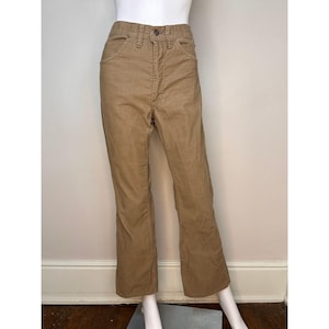 May include: A pair of tan corduroy pants with a straight leg fit.