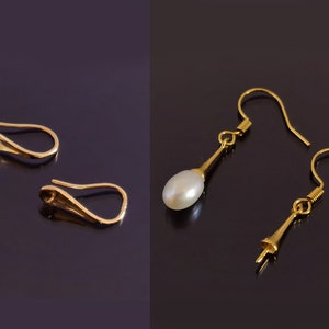 May include: Two pairs of gold earrings with white pearl accents. One pair features a simple drop design, while the other pair has a more intricate, curved design.