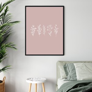 May include: A black framed print with a blush pink background and white line drawings of five different types of flowers.