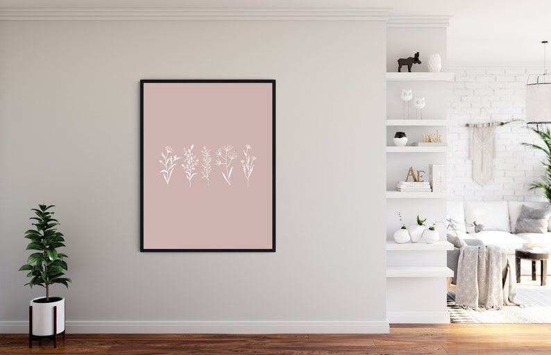 May include: A framed print with a blush pink background and white line drawings of five different flowers.