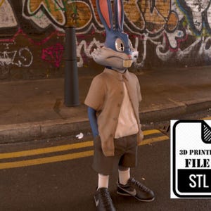 May include: A blue rabbit character wearing a brown shirt and blue shorts stands in front of a graffiti-covered wall. The character is holding a pose with one hand in their pocket and the other hand on their hip. The character is wearing black sneakers. A 3D printer file icon with the text "3D Printer File STL" is in the lower right corner of the image.