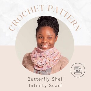 May include: A woman wearing a pink, yellow, and purple crocheted infinity scarf. The image includes the text "CROCHET PATTERN" and "Butterfly Shell Infinity Scarf". A PDF icon is in the lower right corner.