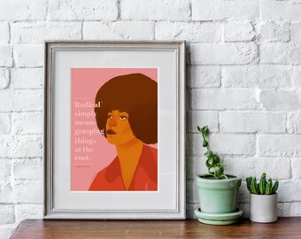May include: A framed print with a pink background featuring a portrait of Angela Davis with an afro hairstyle. The quote "Radical simply means grasping things at the root." is printed below the portrait.