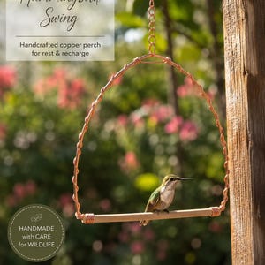 May include: A copper hummingbird swing featuring a twisted wire frame and a wooden perch, suspended by a metal chain. The text reads Hummingbird Swing, Handcrafted copper perch for rest & recharge, and HANDMADE with CARE for WILDLIFE.