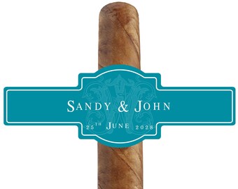 May include: A teal blue cigar band with the text "Sandy & John" and "25th June 2028" on a brown cigar.