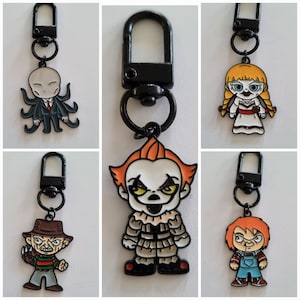 May include: Set of ten horror movie character keychains. Each keychain features a different character from a popular horror movie. The characters include Pennywise the Dancing Clown, Freddy Krueger, Jason Voorhees, Michael Myers, Chucky, Leatherface, Ghostface, and more. The keychains are made of metal and have a black finish. They are perfect for adding a touch of horror to your keys or bag.