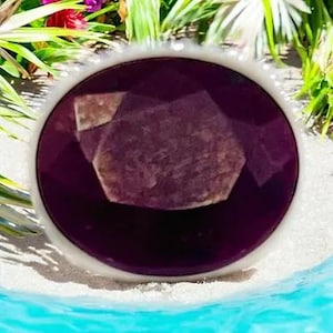 May include: A large, round, purple, gem-shaped coaster with a white border. The coaster is made of a smooth, shiny material and has a slightly raised design.