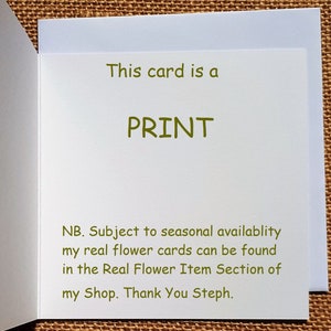 May include: A white greeting card with the text "This card is a PRINT" in green. The card also includes additional text in green, informing the reader about real flower cards. The card is open, revealing the inside.