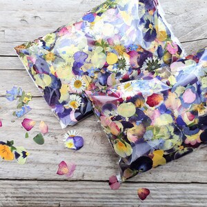 English pressed flower confetti, 75grams of pressed flower petals, beautiful blues, pinks, reds and yellows included. Using lots of different types of flowers that have been grown, pressed and picked by hand.