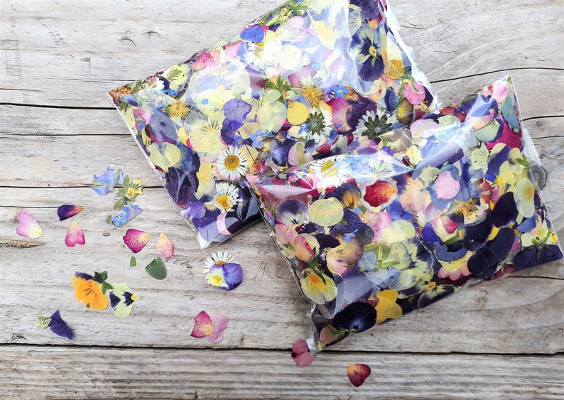 English pressed flower confetti, 75grams of pressed flower petals, beautiful blues, pinks, reds and yellows included. Using lots of different types of flowers that have been grown, pressed and picked by hand.