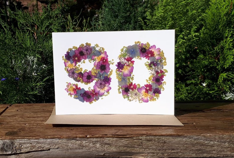 Pressed flowers designed into the number 90, printed onto 300gsm matt white card. Size 8x6 inches. Comes with envelope. There are no real flowers on this card. A personalised happy birthday label and butterflies can be added to the front of the card.