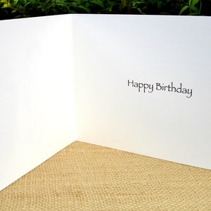 May include: A blank white card with the words "Happy Birthday" printed on the inside.