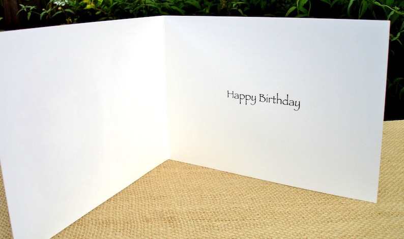 May include: A blank white card with the words "Happy Birthday" printed on the inside.