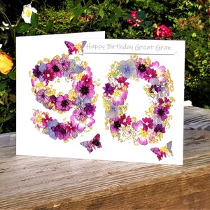 May include: A white card with the number 90 made of pressed flowers. The card says "Happy Birthday Great Gran" at the top.