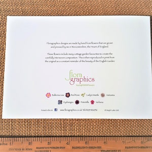 May include: A white card with text describing how the designs are made by hand from pressed flowers. The text includes the phrase "SayingWithFlowers" and a website address. The card also features a small image of a flower with the text "Ballerina rose" below it.