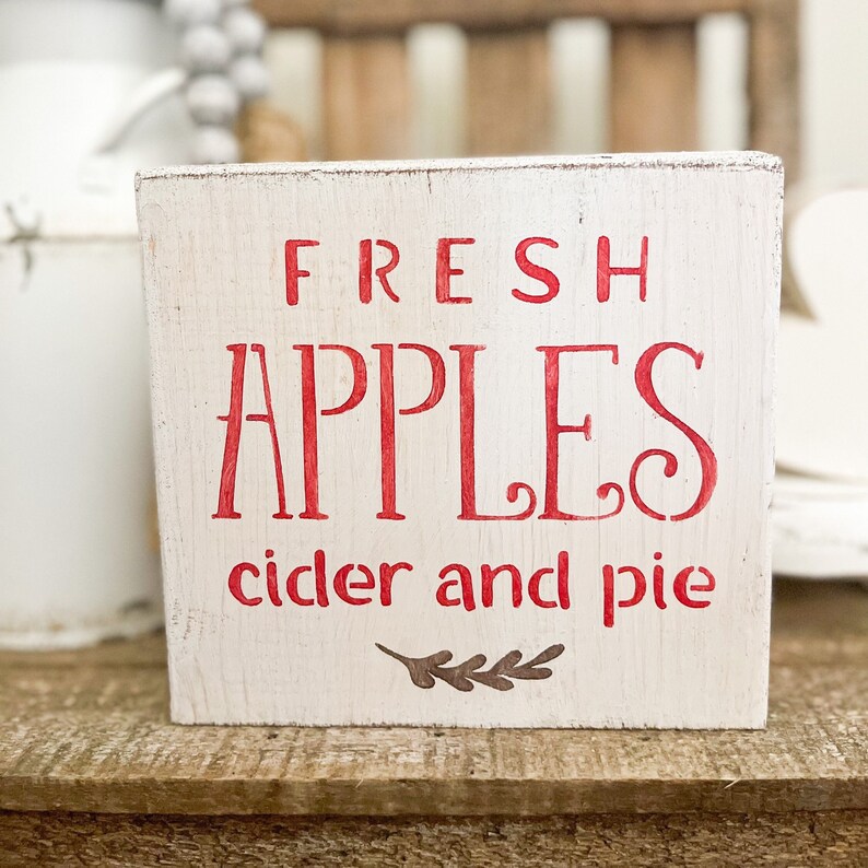 Add a touch of farmhouse charm to your home with our Apples Wood Sign. Perfect for fall, this small wood sign features a delightful apple cider design that will beautifully complement your fall tiered tray and add a cozy touch to your home decor.
