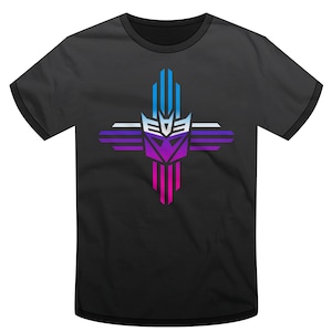 May include: Black t-shirt with a blue, white, and purple graphic of the Transformers logo in the shape of a Zia symbol.