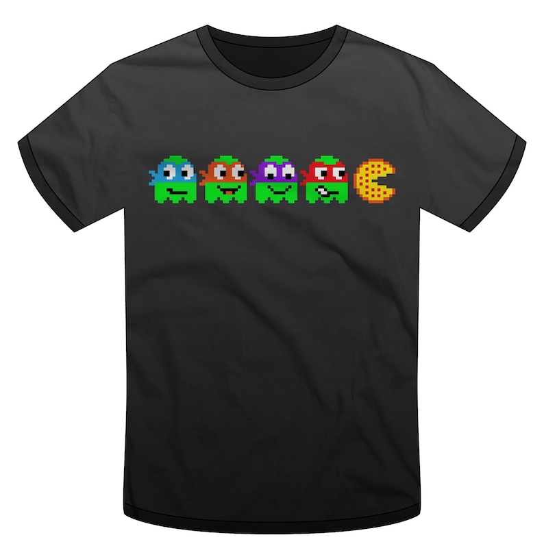 May include: Black t-shirt with a pixelated image of four Teenage Mutant Ninja Turtles dressed as Pac-Man ghosts chasing a pizza slice.
