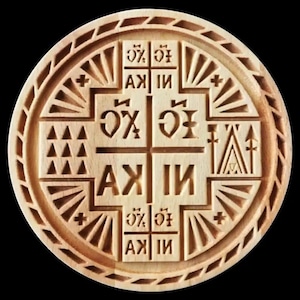 May include: A white ceramic mug with a black handle and the text "But First, Coffee" in a bold, black font. The mug is set against a blurred background, suggesting a cozy setting.