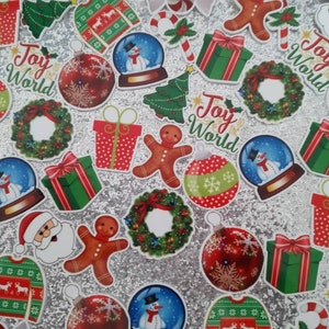 May include: Assortment of Christmas-themed decorations, including ornaments, gift boxes, snow globes, candy canes, wreaths, and gingerbread men. The decorations are red, green, white, and gold. The background is a sparkly silver.