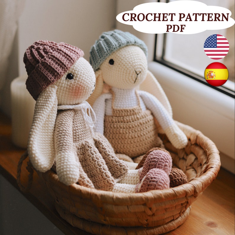 May include: Two crocheted bunny amigurumi toys in a wicker basket. One bunny is wearing a light blue hat and the other is wearing a pink hat. Both bunnies are wearing beige dresses. The image includes the text "CROCHET PATTERN PDF".