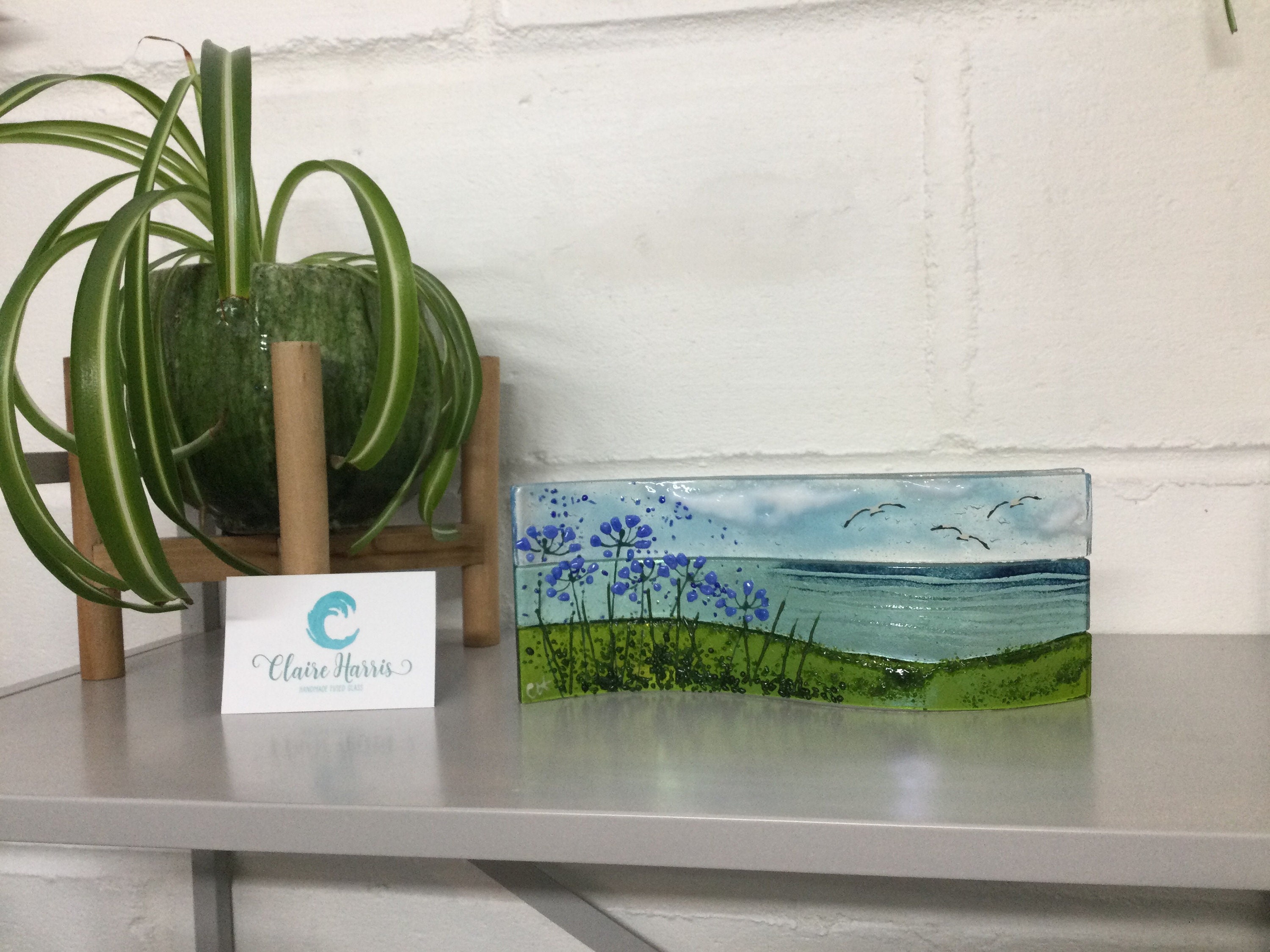 Fused glass, Cornish sea scene with agapanthus. Freestanding wave, 9cm tall. Handmade in Cornwall.