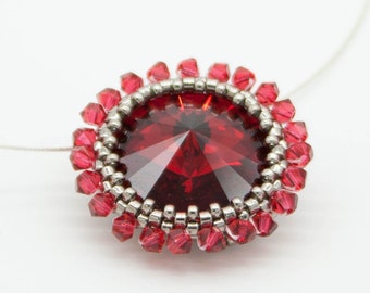 Pendant with red Swarovski crystals and silver japanese glass beads. Stainless steel wire