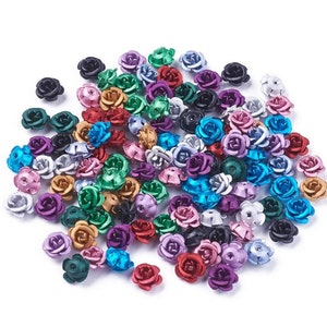 May include: A large assortment of metal rose flower beads in various colors, including silver, gold, blue, green, purple, red, and black.