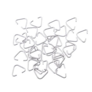 May include: A pile of silver-toned triangle-shaped jump rings. The jump rings are small and are perfect for jewelry making.