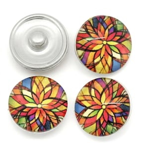 May include: Four circular snap buttons featuring a vibrant, multi-colored geometric floral pattern with shades of red, yellow, orange, green, and blue. One button is shown from the back, revealing a silver metal snap mechanism, while three show the front.