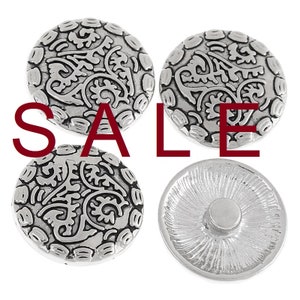 May include: Four silver-colored snap buttons with an ornate, swirling design. One button shows the back with a snap. The word "SALE" is printed in red across the image.