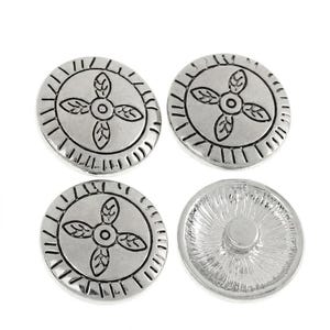 May include: Four round silver-toned metal buttons. Three buttons display a central four-leaf clover-like design surrounded by a radial line border. One button is shown from the reverse side, revealing a smooth circular shank for attachment.