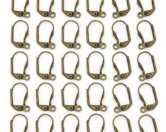 May include: A collection of thirty bronze-toned metal leverback earring findings arranged in a grid. Each earring component features a curved wire loop with a hinged closure mechanism and a small circular loop at the base for attaching jewelry.
