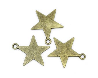 May include: Three antique gold-toned metal star charms with jump rings. The stars have a distressed finish.