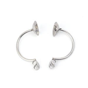 May include: A pair of silver earring findings with a curved post and a cup-shaped top. The findings are designed to hold a cabochon stone.