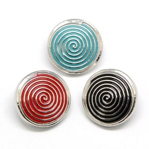 May include: Three circular metal buttons featuring a raised spiral design. One button has a light blue enamel inlay, one has a red enamel inlay, and one has a black enamel inlay. Each button is framed by a polished silver-toned metal border.