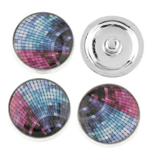 May include: Three circular snap buttons with a metallic silver rim and a mosaic pattern featuring small squares in shades of blue, purple, and pink. One button is shown from the back, revealing a silver metal snap fastener mechanism.