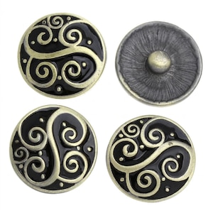 May include: Four circular snap buttons featuring a black enamel inlay with raised, antique gold-toned swirling scrollwork patterns. Three buttons display the decorative front, while one button shows the plain, textured metallic back mechanism.