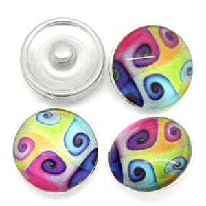 May include: Three circular snap buttons featuring a vibrant, multi-colored pattern of swirling shapes in shades of pink, purple, blue, yellow, and lime green. One button shows the silver metal underside with a central stud, while two show the top.