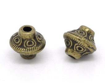 May include: Two antique gold metal beads with a decorative, circular pattern. The beads have a hole in the center for stringing.