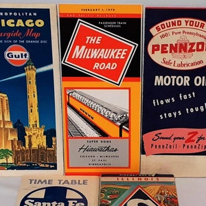 May include: Five vintage travel and advertising brochures. The top left brochure is a blue and white map of Chicago with the Gulf gas station logo. The top center brochure is red and white with the text "The Milwaukee Road" and a picture of a train. The top right brochure is blue and white with the text "Sound Your Z Pennzoil" and a picture of a car. The bottom left brochure is red and white with the text "Time Table Santa Fe" and a picture of a man walking. The bottom right brochure is blue and white with the text "Highway Map of Illinois Skelly" and a picture of a car.