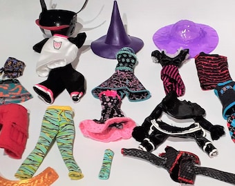 May include: A collection of doll clothes and accessories for a monster high doll. The set includes a variety of colorful clothing items, including dresses, pants, shirts, and a hat. There are also accessories such as a belt, a scarf, and a pair of shoes.
