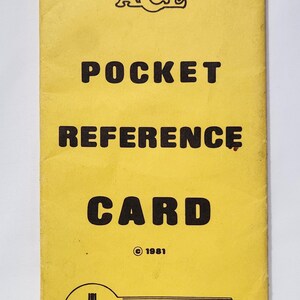 May include: Vintage yellow Pocket Reference Card for Atari video games. The card features the Ace logo, the Atari logo, and the text "Unlock Your Atari". The card is from 1981.