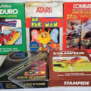 May include: Five vintage Atari 2600 video game cartridges. The cartridges are in their original boxes. The games are Enduro, Ms. Pac-Man, Combat, Lock 'n' Chase, and Stampede.