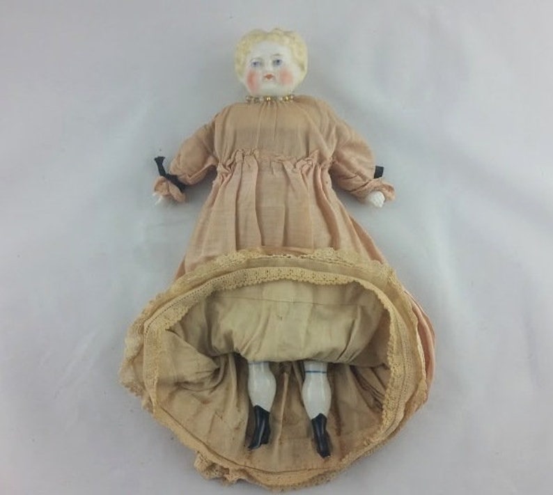 antique porcelain doll with cloth body