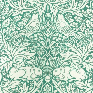 May include: A teal green fabric with a white repeating pattern of stylized birds, rabbits, and floral designs. The pattern is reminiscent of Art Nouveau style.