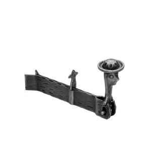 May include: A silver-toned metal tie clip with a whimsical design featuring a small figure wearing a hat and another figure standing on a platform.