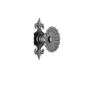 May include: A black metal door handle with a decorative floral design. The handle has a round knob with a fluted edge and a square backplate with a fleur-de-lis design.