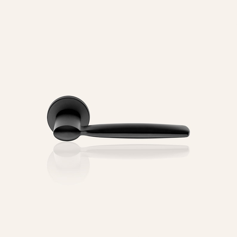May include: A black door handle with a rounded lever and a round base.