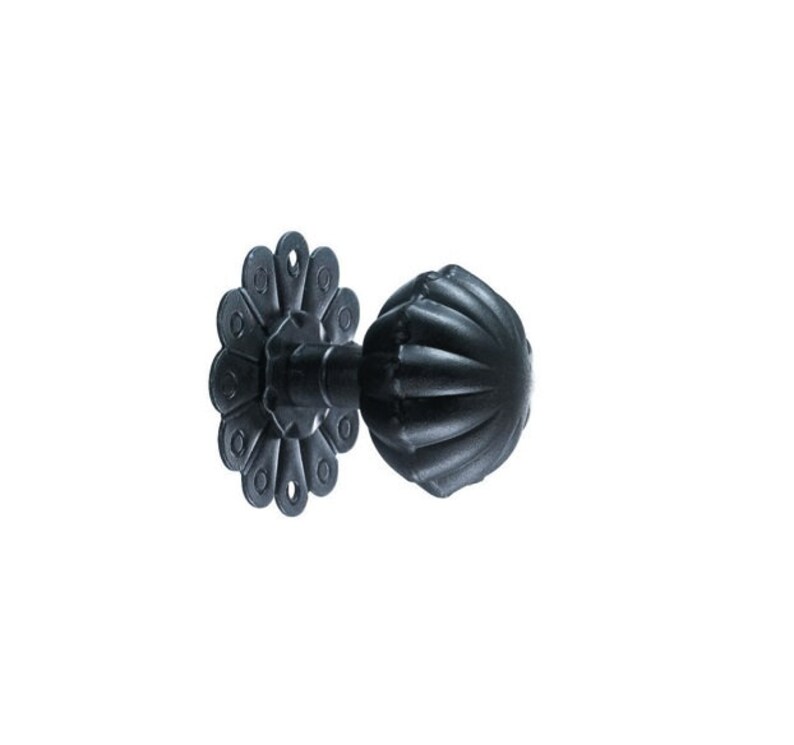 May include: Black metal curtain rod finial with a fluted ball design and a decorative flower-shaped base.